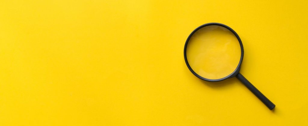 close-up-magnifier-glass-yellow-background
